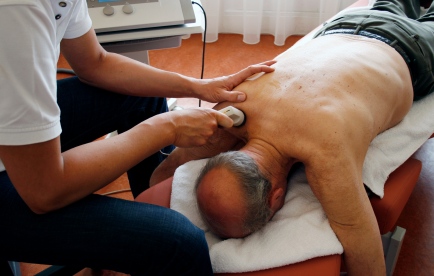Man receiving Ultrasound therapy from chiropractor